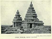 Temple with two towers, with two people in front for scale