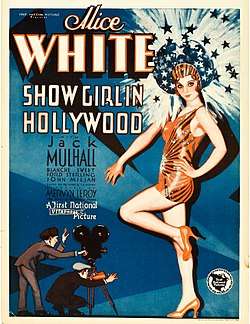 Movie poster featuring a large illustration of a young woman wearing a short orange-red dance outfit, high heels, and headdress. Her head is surrounded by shooting stars and sparkles. At her feet, much smaller-scaled, are two men—one is shouting through a megaphone, the other is operating a movie camera. The accompanying text is dominated by the name of star Alice White.