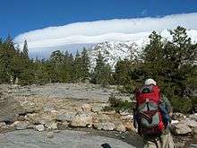 Strangely smooth and undulating cloud above the snowy Sierra Nevada mountaintops