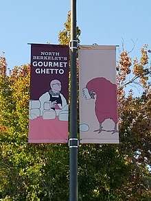 A street banner on a pole announcing that the visitor is in Berkeley's "Gourmet Ghetto" neighborhood.