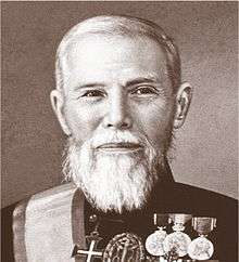 Sepia portrait of a distinguished man with a white beard wearing his decorations