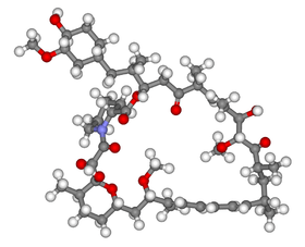 A 3D skeleton of the molecular structure consisting of over around fifty small grey spheres representing carbon, linked by grey tubes. Attached to these are white spheres representing hydrogen. There are a handful of red spheres representing oxygen, and one blue sphere, which is nitrogen.