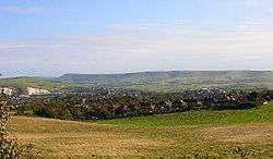 Modern photograph of the site of the Battle of Lewes 1264. The battle was fought between Simon de Montfort and Henry III in the field in the foreground with the former being victorious. Lewes castle and Southerham chalk pits to the left and Beddingham Hill behind it with the town of Lewes.