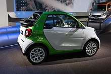 Side view of white and green Fortwo Cabrio Electric Drive at IAA 2017 in Frankfurt.