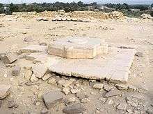 Huge limestone blocks on the ground, in the shape of Egyptian hieroglyphs.