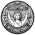 A circular, black and white logo with a style suggesting late Art Nouveau or early Art Deco. Soroptimist International describes it as follows: "The emblem consists of a circular disc on which the figure of a woman holds the banner 'Soroptimist' in uplifted arms, spreading sunrays from the background. [From] the banner on one side fall acorns and leaves of oak and on the other side, leaves of laurel. [The] word 'International' completes the outer circle."