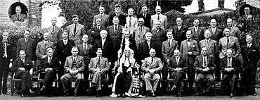 A formative photograph of about 30 politicians, standing and sitting in four rows