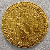 Gold coin of medieval vintage showing a woman seated on a throne