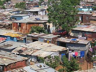 A shanty town located in Soweto, Johannesburg. Many dwellings are shown throughout the photograph.