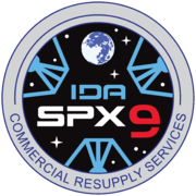 NASA's SpX-9 mission patch graphic simulates the view from inside IDA-2, displaying the three petals of the docking adapter.