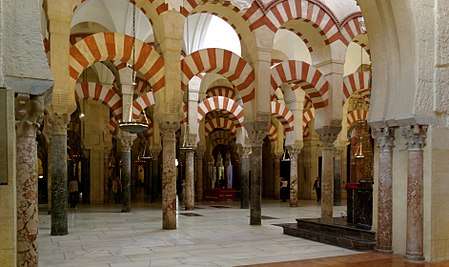 Inside of a mosque, with archways and pillars