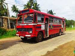 Red bus on a rural road