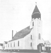 Exterior view in 1933: white wooden church on a city street corner