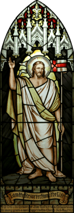 High resolution, perspective corrected stained-glass image of Jesus with a halo, dressed in white and gold robes, with his hand raised, and the banner "I am the Resurrection and the Life", together with a dedication to a deceased parishioner