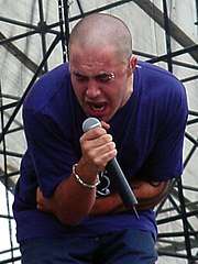 A man with a microphone performing with vocals