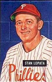 A baseball card image of a smiling man wearing a white baseball uniform with red pinstripes and a red baseball cap with a white "P" on the front