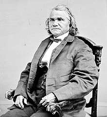 Formal photograph of a seated Stand Watie, in European dress