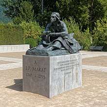 Outdoor statue of a seated Jean-Paul Marat