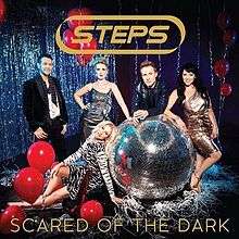 A single cover with two men and three women around a silver, glittering disco ball