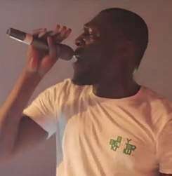 A photograph of Stormzy performing live.