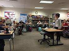 Students act out a mock trial in their classroom