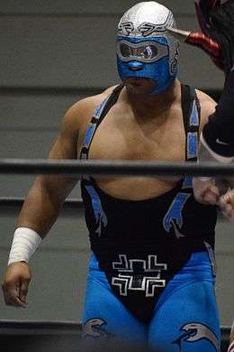 A color photograph of professional wrestler Rey Bucanero making his way to the ring