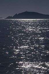 Photo of Sumburgh Head in the distance across a long body of water