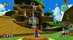 This screenshot shows Mario standing before a hillside lined with enemies and obstacles. The game's interface displays the collected number of Power Stars, life meter, number of coins and Star Bits, and number of lives