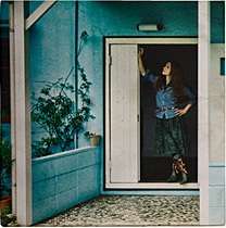 A woman standing in a doorway.