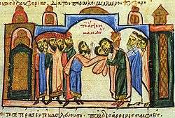 Beneath a domed superstructure, a delegation of bearded men stands left, in the center, a man surrenders a cloth with the face of Christ to another man, who kisses it, while churchmen stand to the right.