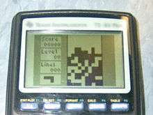 The game Tetris is being played on a TI-83 Plus.
