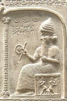 Representation of Shamash from the Tablet of Shamash (c. 888 – 855 BC), showing him sitting on his throne dispensing justice while clutching a rod-and-ring symbol