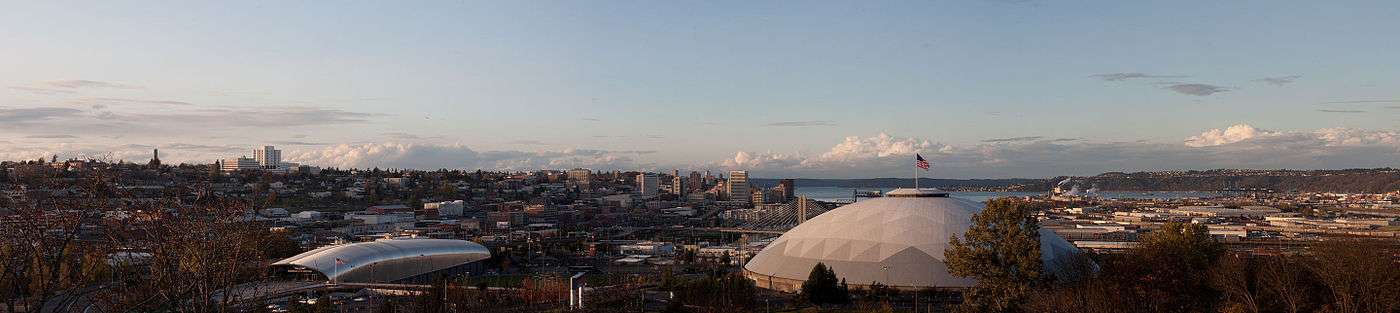 Panorama of Tacoma from the McKinley neighborhood with the Tacoma Dome in the foreground and Puget Sound in the background.