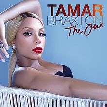 An image of a woman with a blonde ponytail, bright red lips, and a low-cut dress. She is seating on a chair and posing with her arm draped over her head while looking at the camera. The words "Tamar Braxton" are included in all capital letters and the words "The One" are in a cursive font.