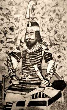 Black-and-white copy of a Persianate miniature, showing a bearded middle-aged man, wearing armour and helmet, seated cross-legged on a low throne