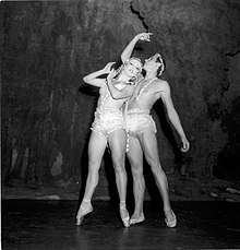 a female and a male ballet dancer striking a dramatic pose