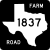 Image of FM 1837 highway shield. The square shield has a white symbol in the shape of Texas as the state appears on maps on a black background. Inside this symbol is the number 1837. The black background contains the word FARM in the upper right corner and the word ROAD in the lower left corner.