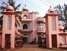 Ornate, pink-and-white building with traditional Mughal architecture