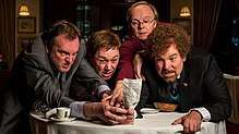 Four men grasping a restaurant bill
