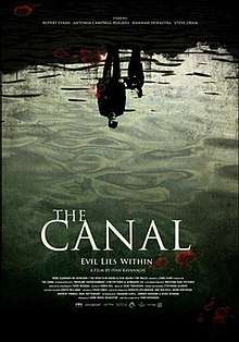 A film poster showing the reflection of man and a young boy in the water.  At the bottom of the poster, the tag line says, "Evil lies within".