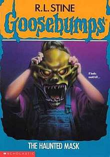Cover of the book, showing a girl holding a green Halloween mask over her face