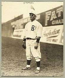 Stengel stands in the outfield, playing his position and wearing sunglasses