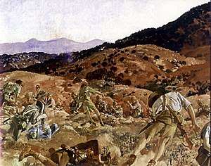 A reproduction image of a painting in which a battle scene is depicted. The terrain is rocky and undulating and men in shorts and shirts carrying rifles are falling to the ground as they are shot down from defenders standing in another trench.