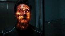 The fiery extremus virus inside the character Chan Ho Yin begins to explode, his face glowing orange