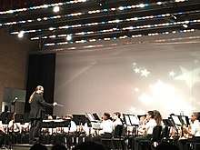 Conductor leads band students onstage