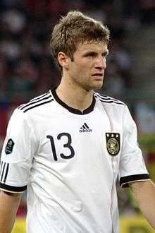 Thomas Müller standing on a field