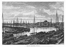 Nineteenth century engraving of river port with large number of single-masted flat bottom boats berthed