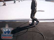 Top coating a commercial flat roof