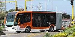 Orange-and-white articulated bus