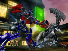 Screenshot of Xbox gameplay, showing Optimus Prime attacking an unknown Decepticon. A stylized Shanghai street fills in the background.